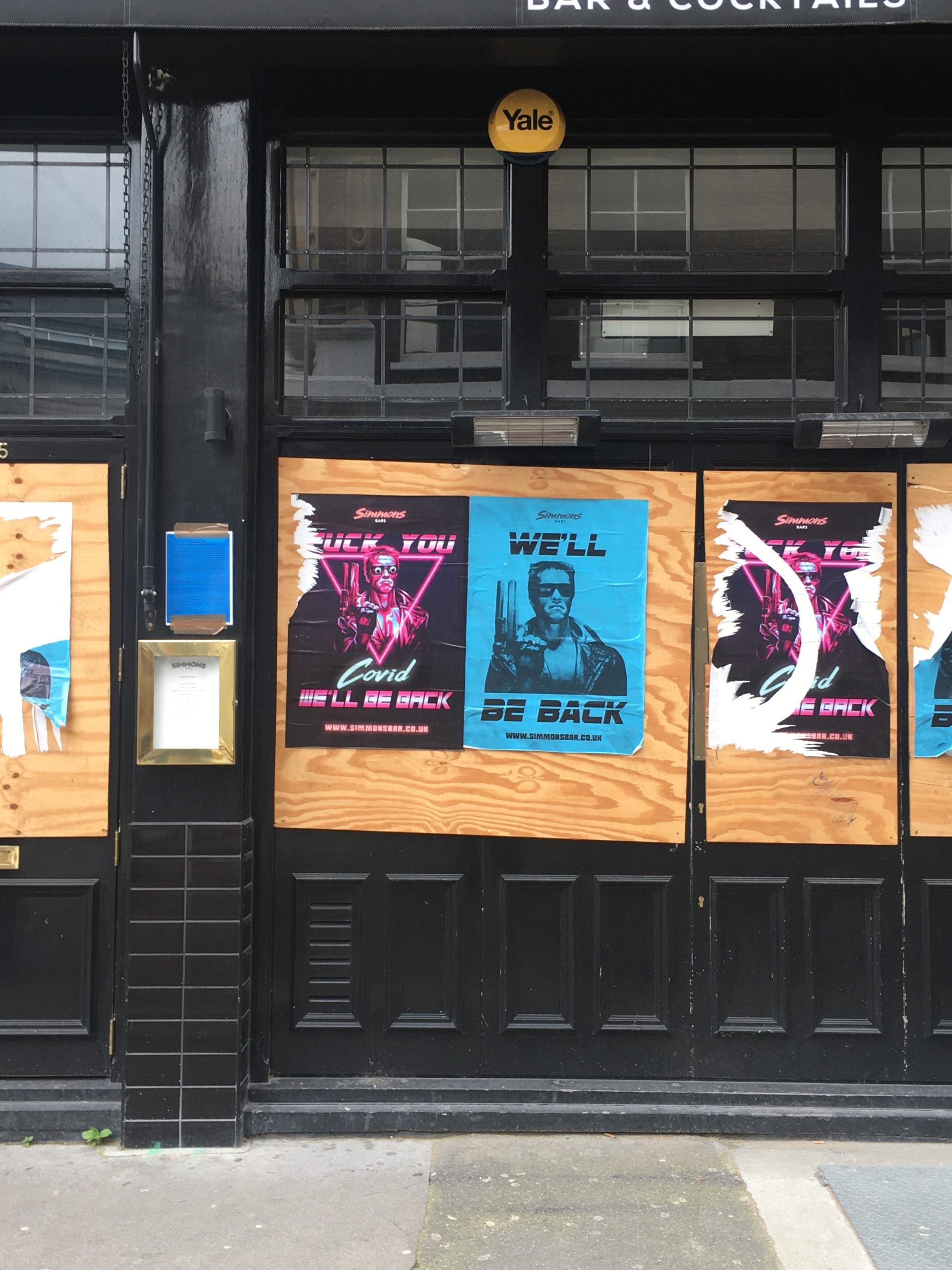 Posters on doors of an empty pub in North London